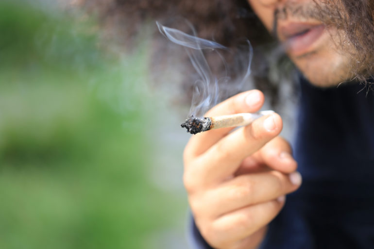 Man smoking a cannabis joint