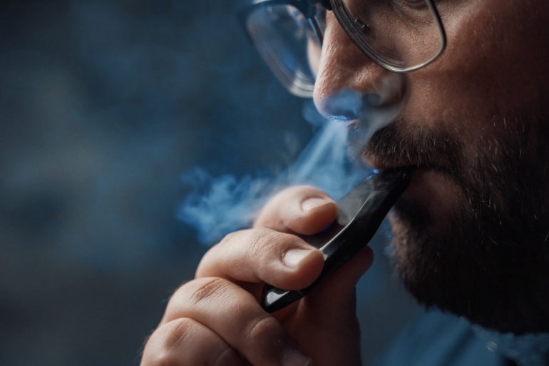 Inhaling nicotine vapor from an e-cig
