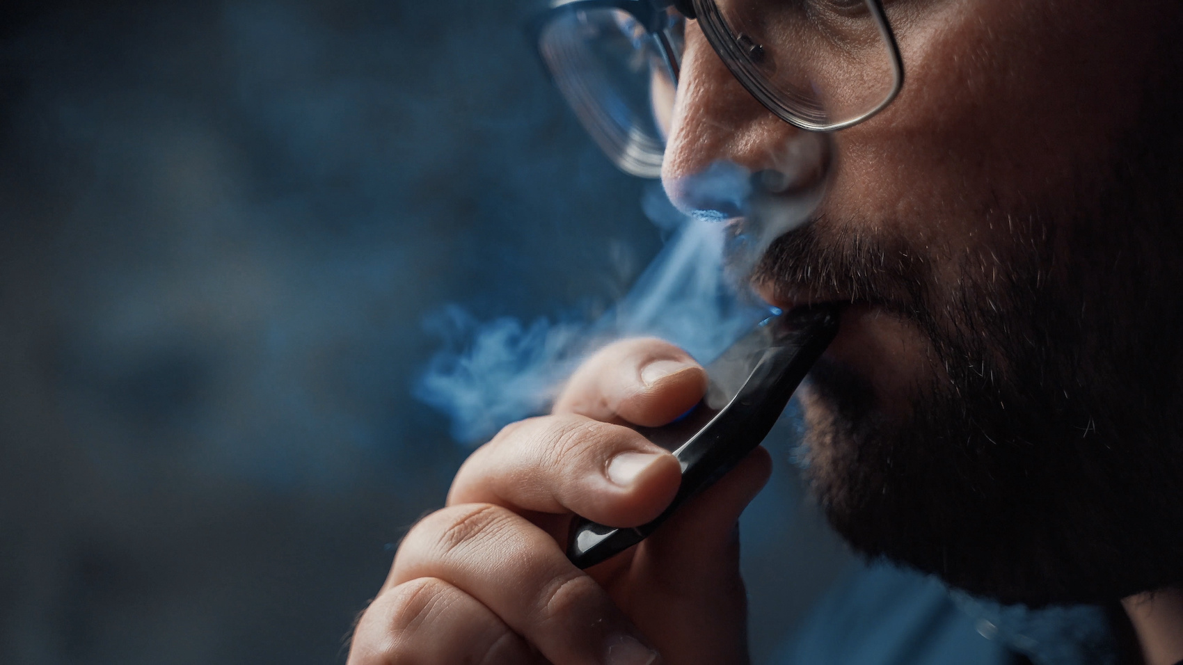 Inhaling nicotine vapor from an e-cig