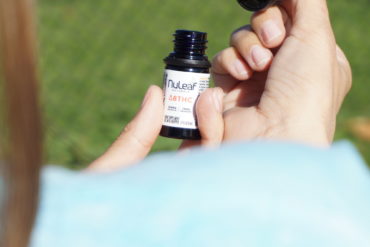 Woman using a delta-8 THC oil tincture for medical benefits
