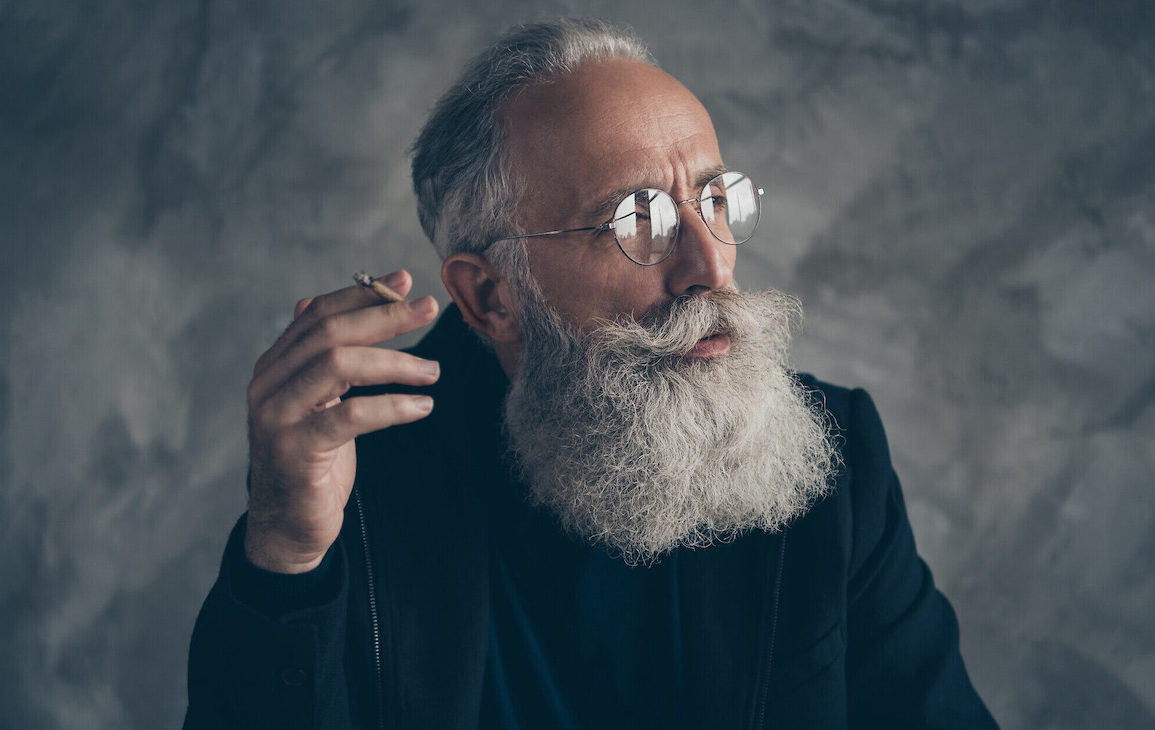 Old man smoking cannabis joint