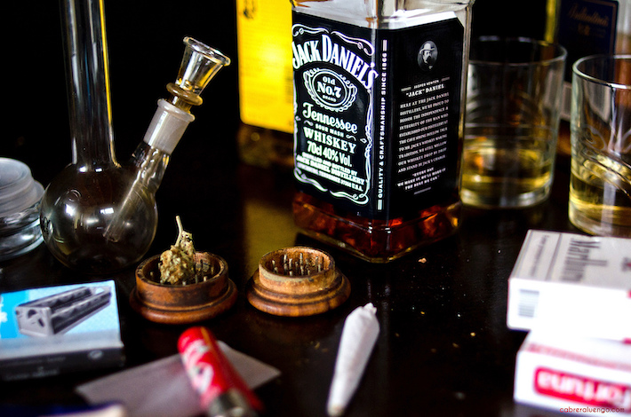 Cannabis flower and joints with bottle of Whiskey