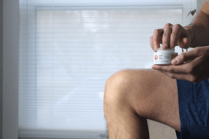 Applying CBD balm to muscle for pain relief