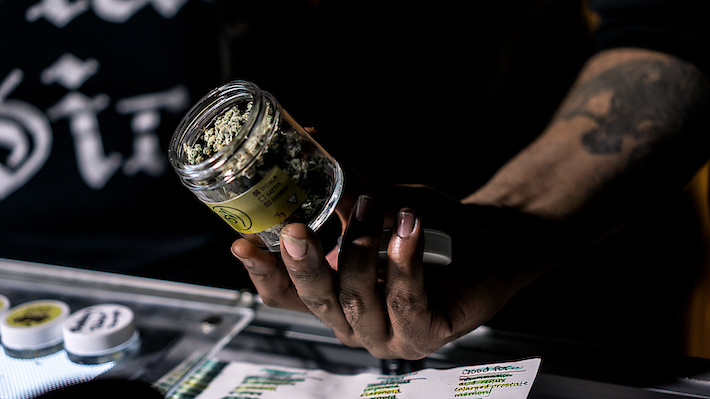 Budtender selling CBD product at a dispensary