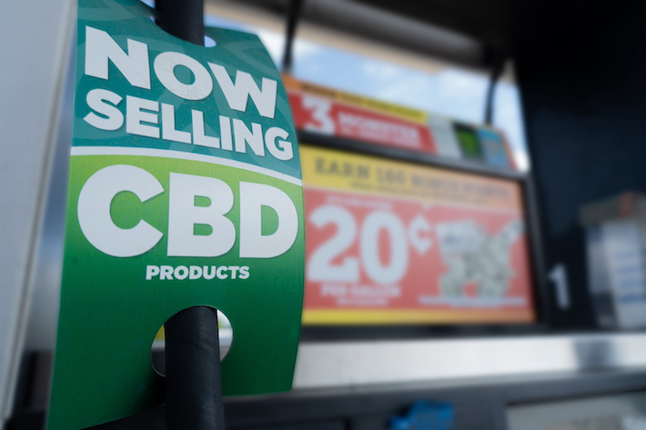 CBD promotional product sign at a gas station
