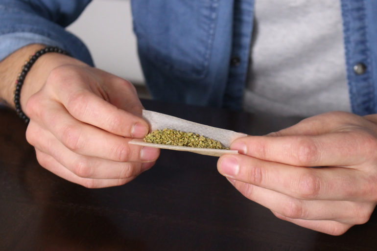 Cannabis user rolling a joint