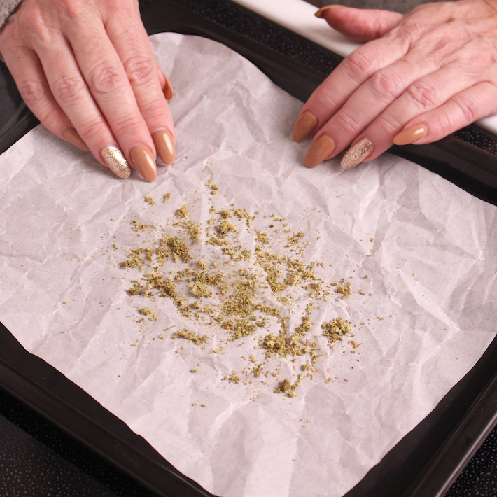 Placing cannabis flower on baking tray