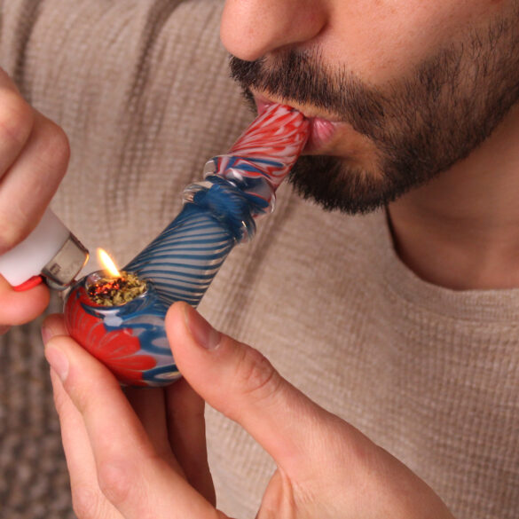 Man smoking cannabis from a clean pipe