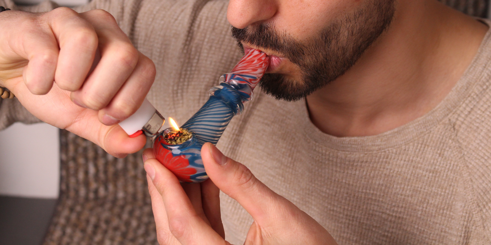 Man smoking cannabis from a clean pipe