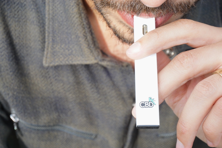 Product expert is testing a CBD vape pen to measure its quality and performance