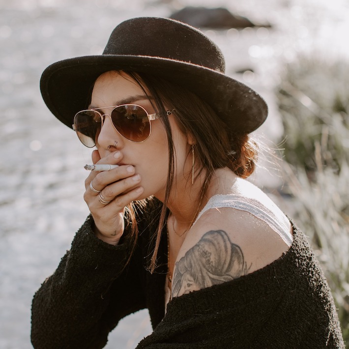 Woman smoking a full spectrum CBD cigarette