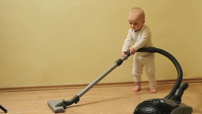 Baby cleaning floor with vaccum