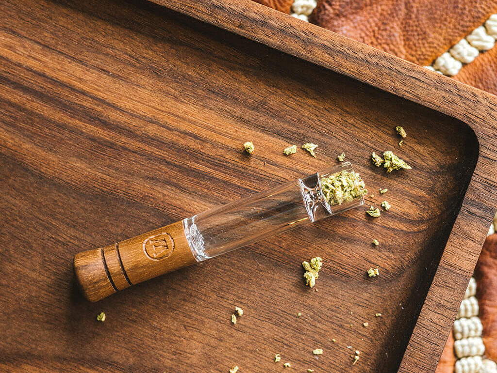 Using a one-hitter cannabis pipe