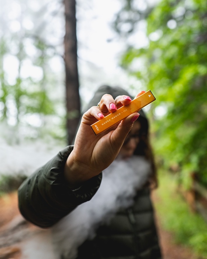 Vaping CBD in nature while hiking