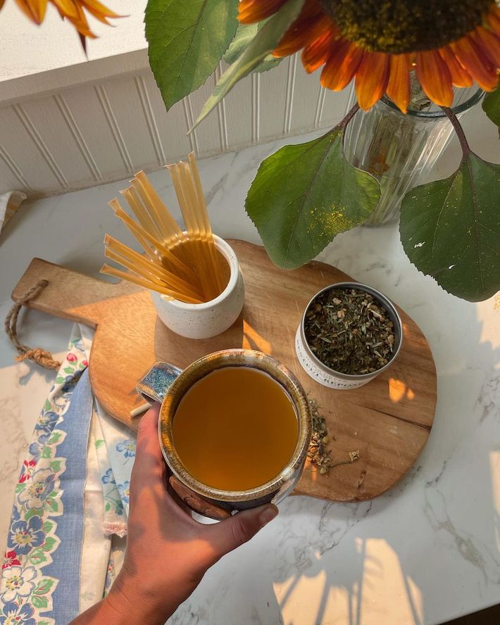 Adding CBD honey sticks to a tea beverage