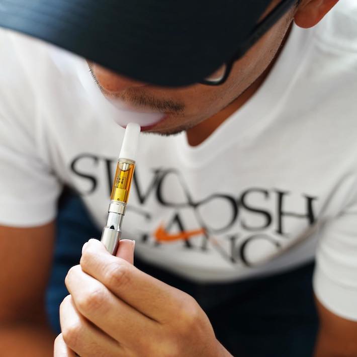 Man vaping a CBD vape pen without THC
