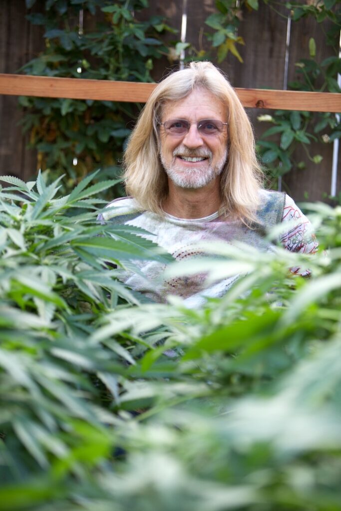Jorge Cervantes behind cannabis plants