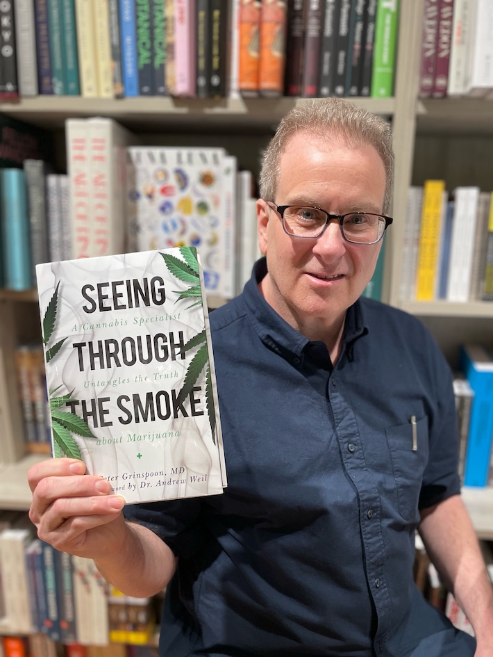 Dr. Peter Grinspoon holding his new book Seeing Through the Smoke at a bookstore