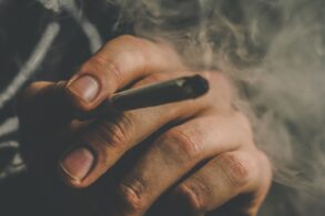 Man smoking a cannabis joint with big clouds of smoke