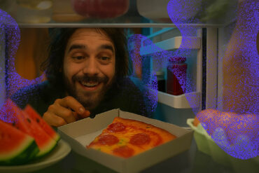 Cannabis user choosing a healthy munchie food from the fridge instead of pizza